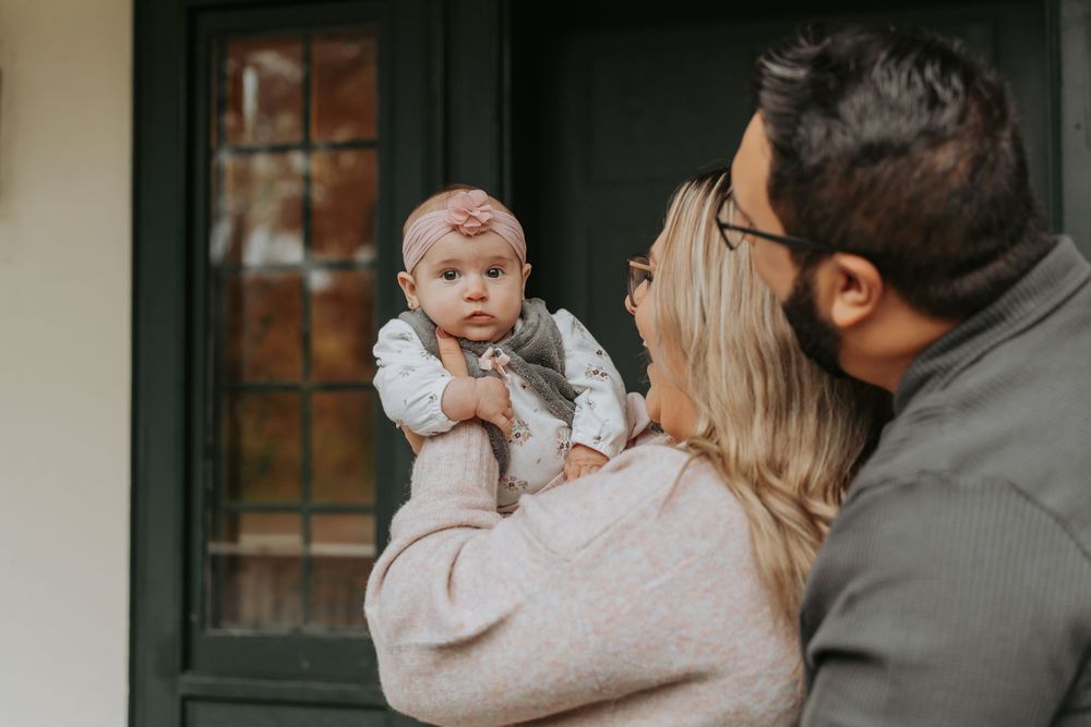 A family with their baby at their front door